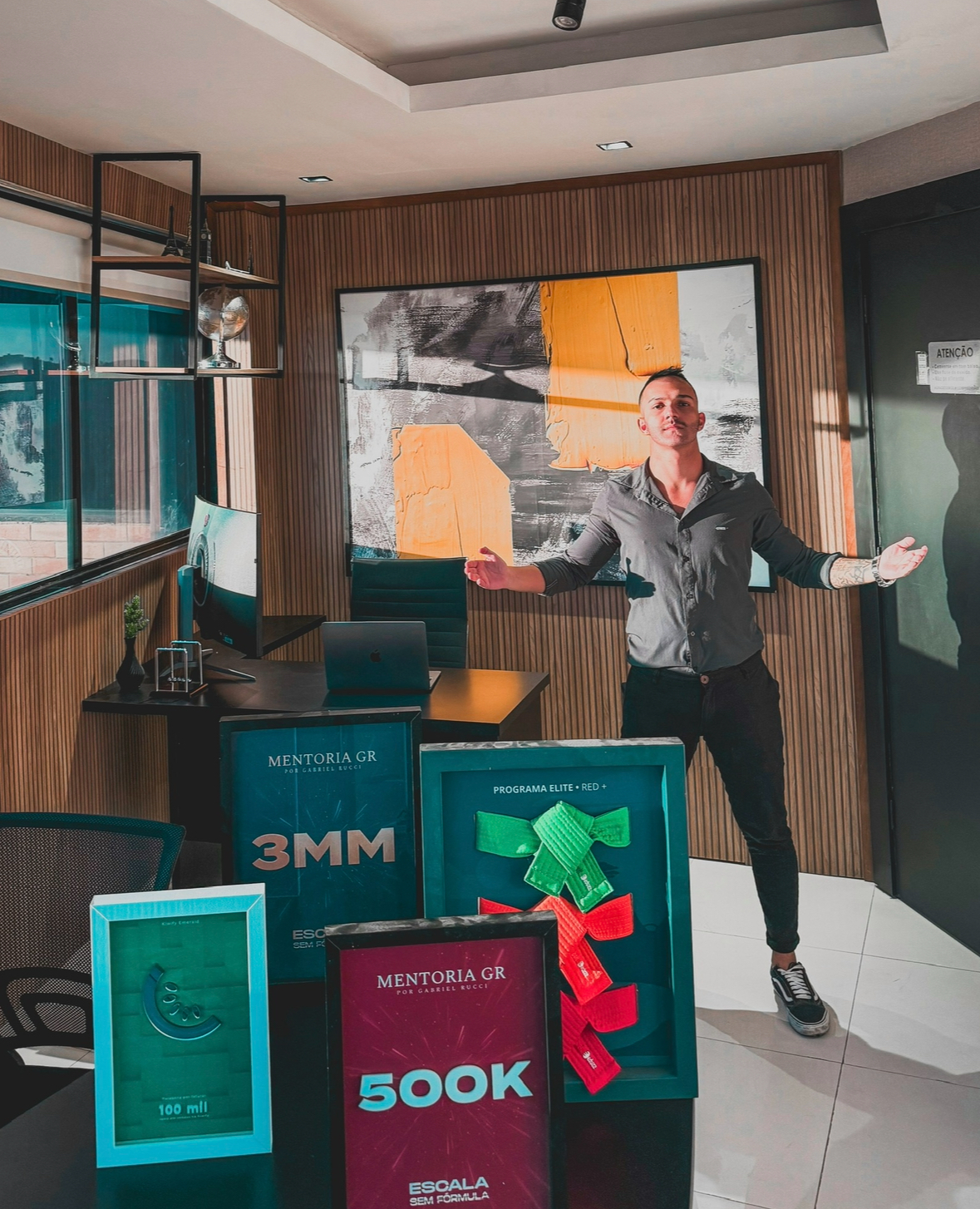 Office display with multiple achievement plaques including 3MM, 500K, and 100 mil awards